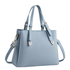Light blue faux leather handbag with geometric arrow texture and gold hardware detailing