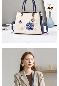 Detailed embroidery of blue flowers and butterflies on a stylish contrast tote bag