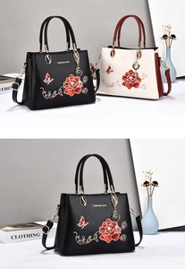 Detailed close-up of premium tote bags with exquisite peony embroidery and metal charms