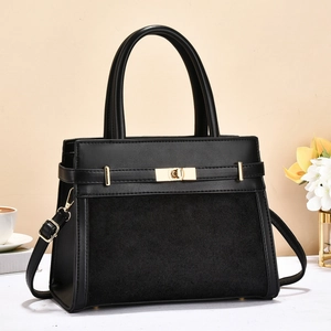 Chic black leather handbag with gold metal clasp and adjustable strap for daily commute