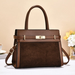 Brown leather and suede patchwork crossbody handbag with gold twist-lock and top handle