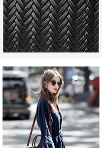 Close-up of black woven leather texture with brown strap on a stylish crossbody bag