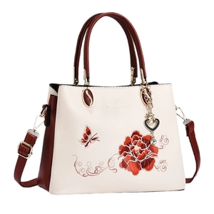 Embroidered Chinese style handbag with gold circular handles and floral butterfly motifs