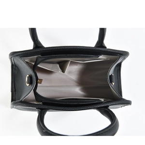 Internal view of black tote bag showing grey wavy lining and functional pockets