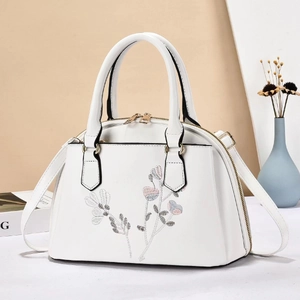 Elegant white PU leather handbag with floral embroidery and golden hardware details
