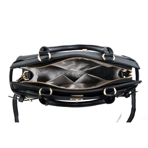 Internal view of black handbag showing three compartments and gold hardware