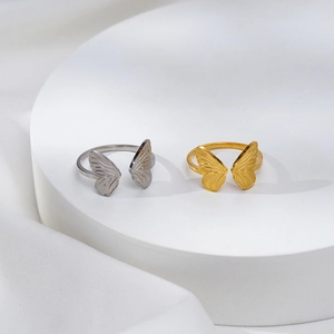 Minimalist adjustable butterfly rings in gold and silver finish on display stand