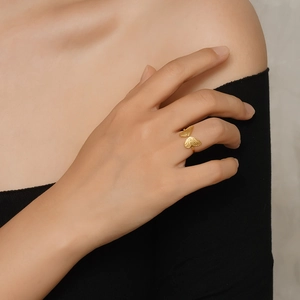 Golden butterfly open adjustable ring with textured wings shown on a model hand