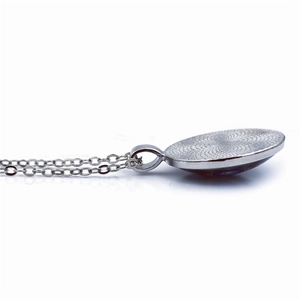 Silver Zelda time gem necklace showing precision concentric radial groove texture
