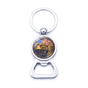 Detailed close-up of a silver US 250th anniversary keychain and beer bottle opener