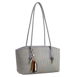 Chic woven tote bag with herringbone pattern and decorative wooden beads on white background