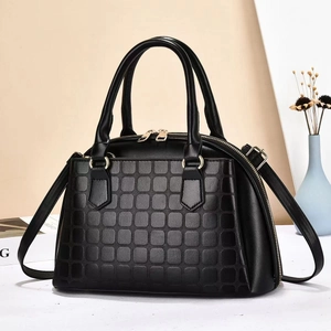 Chic black shell-shaped handbag with textured embossing and elegant gold hardware