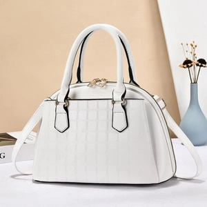 White faux leather shell handbag with square embossed texture and golden hardware accents