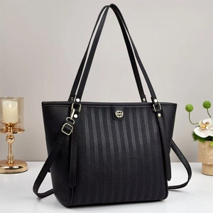 Black embossed leather tote bag with gold metal buckle and detachable shoulder strap