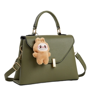 Green trapezoid tote bag in litchi texture with brown plush bunny and gold clasp buckle