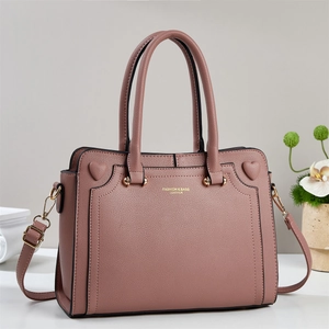Dusty pink faux leather tote bag with gold heart decor and adjustable shoulder strap