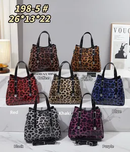 Detailed view of large leopard print patent leather handbags in seven distinct color options