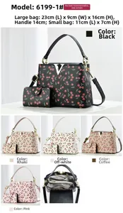 Detail view of cherry print bucket bag set showing inner structure and metallic V logo