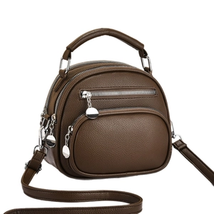 Classic dark brown pebble leather crossbody bag with multiple zippers and top handle