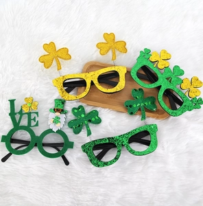 Macro shot of St. Patrick's Day party glasses with green glitter clovers and festive motifs