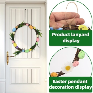 Easter wreath with colored eggs and green leaves on white wood door with lanyard detail