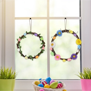Detail of Easter egg wreaths with green leaves and colorful flowers on natural rattan base
