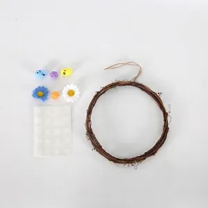 Easter floral grapevine wreath with colorful speckled eggs and daisy flowers decoration