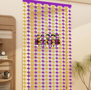 Detail of graduation tassel curtain with purple and yellow mortarboard cap decorations