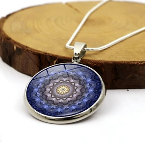Retro mandala glass dome pendant necklace with silver snake chain on wooden background