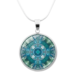 Macro detail of silver mandala pendant necklace with symmetrical blue-green geometric art