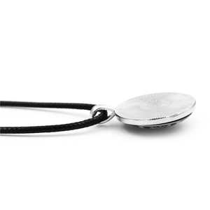 Minimalist silver four-leaf clover necklace with textured metal pendant and black cord