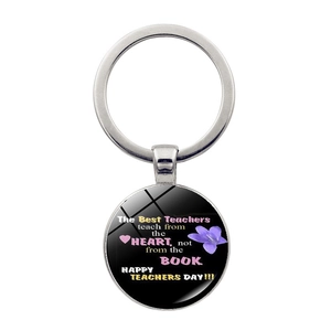 Close-up of silver keychain with Best Teachers heart message and floral design
