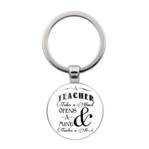 Detailed close-up of a silver teacher appreciation keychain with inspirational text