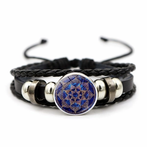 Detail of multi-layer leather bracelet with blue mandala glass dome and metallic beads