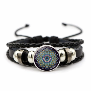 Detail of multi-layer leather braid and colorful mandala glass charm on the bracelet