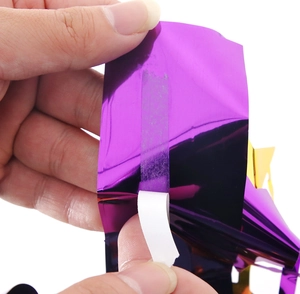 Detail of self-adhesive backing on purple metallic fringe curtain for graduation party