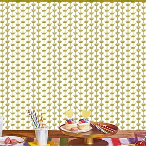 Detail view of gold crown pattern backdrop set up for a festive birthday party scene