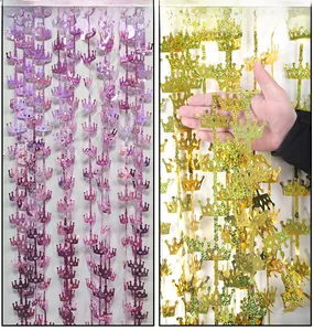 Close-up of laser glitter crown fringe curtains in purple and gold for party decor