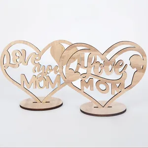 Detail of laser-cut wooden heart ornament with Love you MOM text and round base