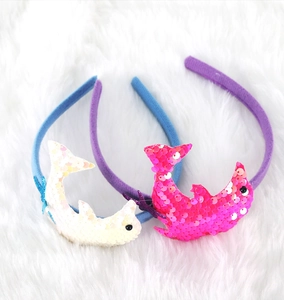 Detail of glittery dolphin sequin headbands for kids in blue and violet fabric