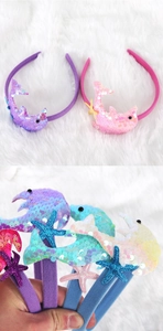 Close-up of colorful sequined dolphin and starfish headbands for mermaid themed parties