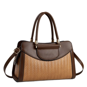 Retro patchwork handbag with woven texture and gold hardware on white background