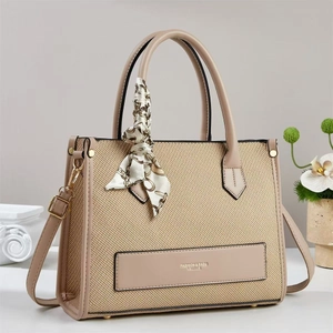 Retro beige woven tote bag with leather trim and silk scarf detail shown in lifestyle setting