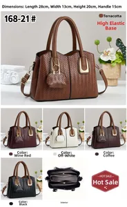 Close-up of woven texture handbag with removable shoulder strap and mini charm