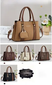 Detailed interior view of handbag with multiple zipper compartments and dimensions