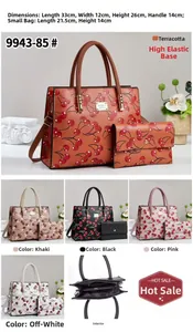 Detail view of cherry print tote set including main handbag and small matching pouch