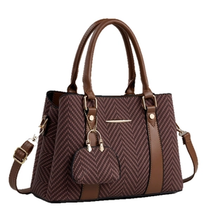Brown herringbone textured handbag with detachable shoulder strap and mini coin purse