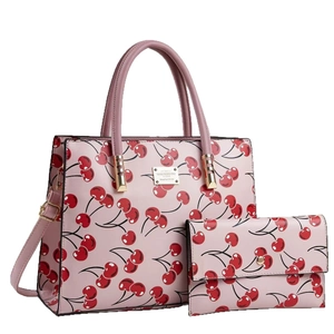 Pink tote bag and wallet set featuring all-over cherry patterns and adjustable strap