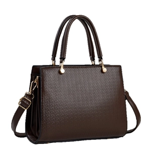 Brown multi-layer handbag with geometric embossing and gold hardware on white background