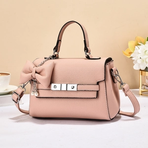 Pink lychee grain leather tote bag with metallic buckle and decorative pearl bow